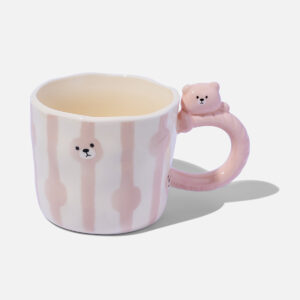 Pink and white ceramic mug with hand-painted circle patterns and a cute pink bear-shaped handle