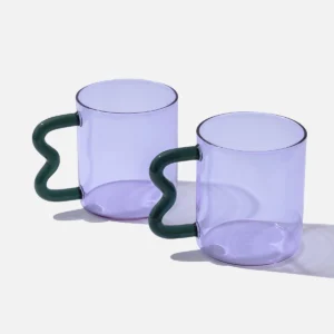 Purple glass mug with a teal wavy handle, modern handcrafted design