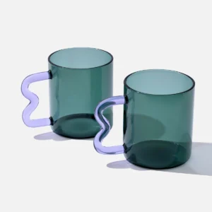 Teal glass mug with a purple wavy handle, modern handcrafted design