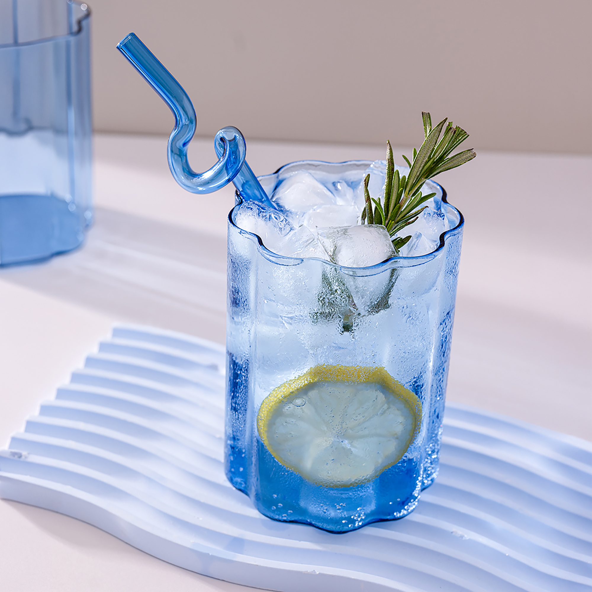 Blue Ripple Glass styled with fresh lemon, rosemary and natural light for a modern home aesthetic.